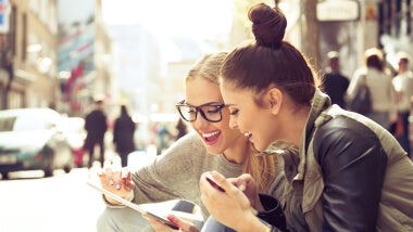 two women smiling at phone