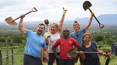 Global Angels volunteers posing with shovels after completing dig Global Angels volunteers posing with shovels after completing dig