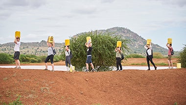 Global Angels volunteers carrying jerry cans Global Angels volunteers carrying jerry cans